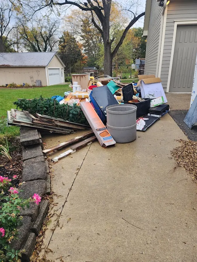 Dumpster being loaded with debris for Estate Cleanout Dumpster Rental in Asheville